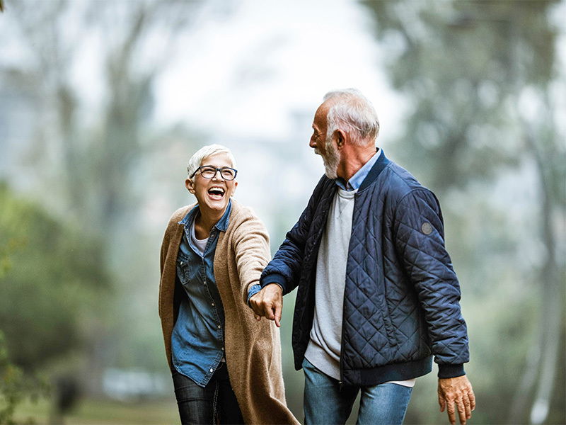 Mature vital couple in the woods Life Extension, mature vital couple being active and laughing in the woods